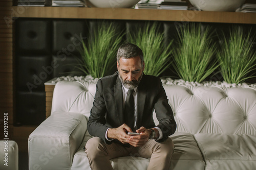 Senior businessman using mo...