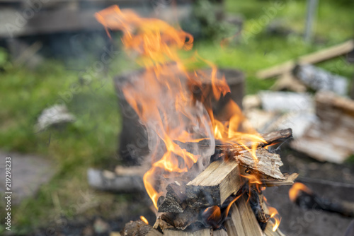 Flame of wood burning in brazier during the preparation for cooking BBQ.