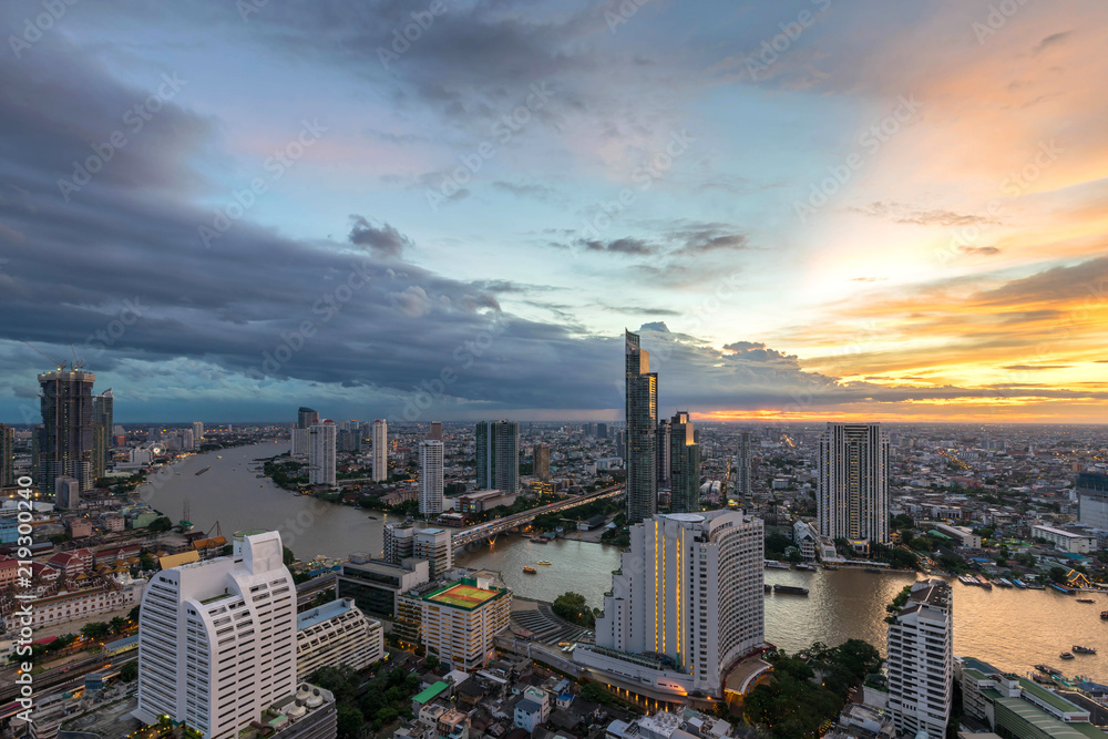 Fototapeta premium Night of the Metropolitan Beautiful sunset curve Chao Phraya River long exposure light Bangkok City downtown cityscape urban skyline - Cityscape Bangkok city Thailand