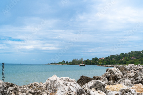 Fototapeta Naklejka Na Ścianę i Meble -  Catamaran Cruise along tropical island coastline 