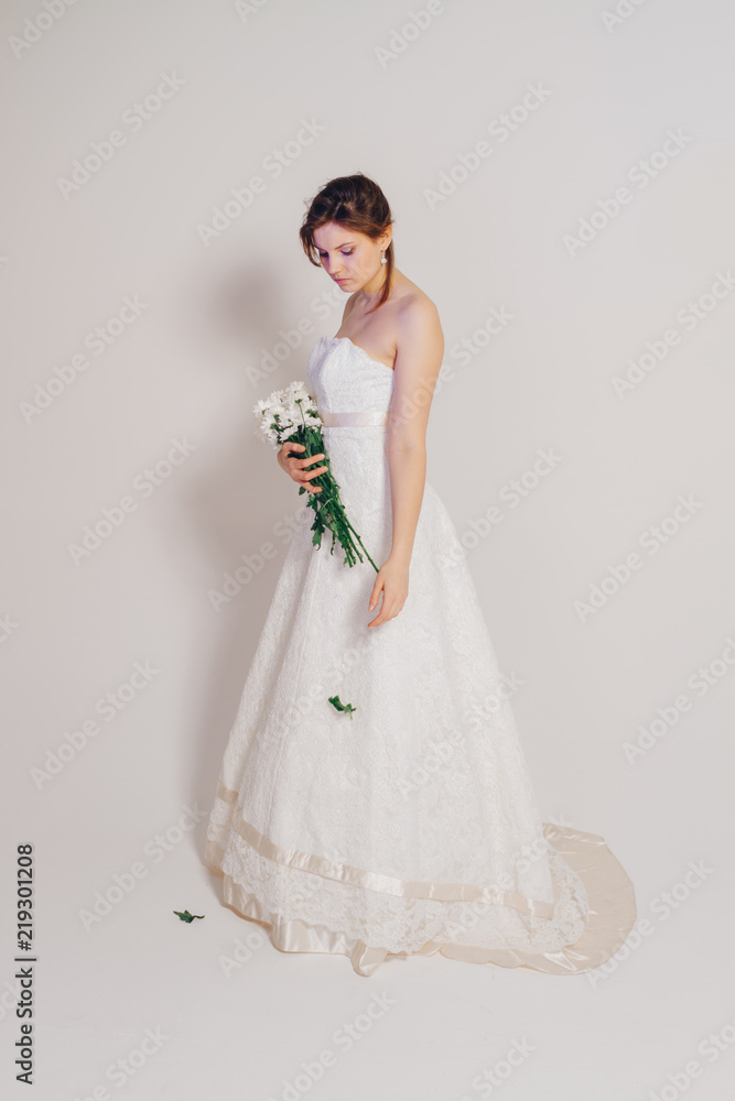 beautiful tender bride with simple bouquet in studio beautiful tender bride with simple bouquet in studio