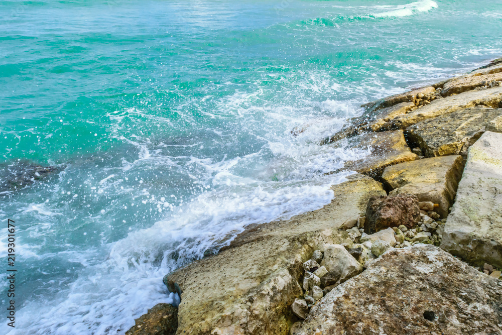 Ocean waves splashing against large rocks by the sea in Montego Bay, Jamaica. Ocean waves splashing against large rocks by the sea in Montego Bay, Jamaica.
