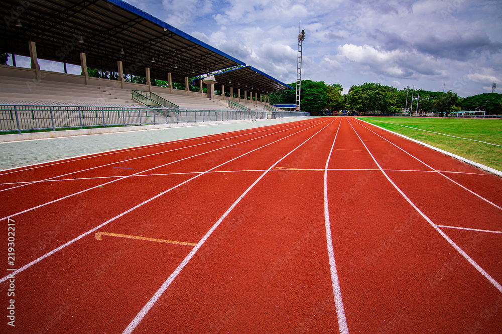 Red running track in the stadium.white line and Green lawn