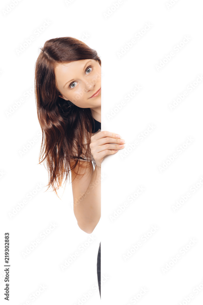 Beautiful brunette woman holding white signboard at white background
