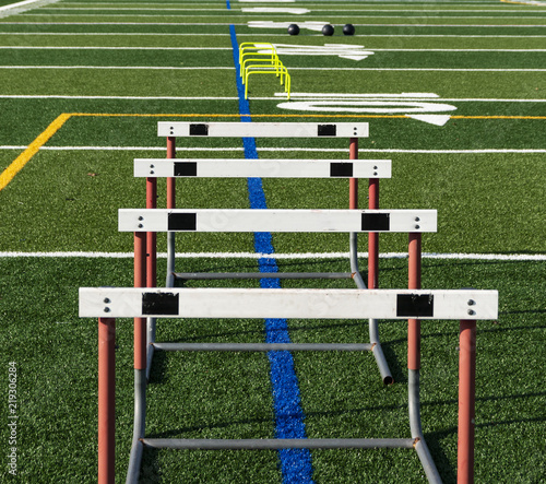 Hurdles and med balls on turf for practice