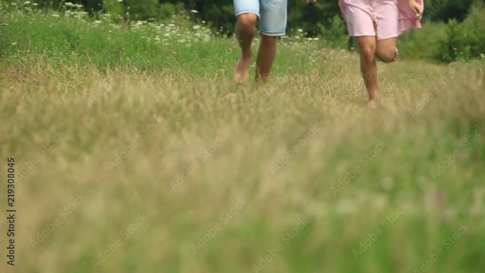 Male and female run togeter in field. Romantic atmosphere. slow motion Male and female run togeter in field. Romantic atmosphere. slow motion