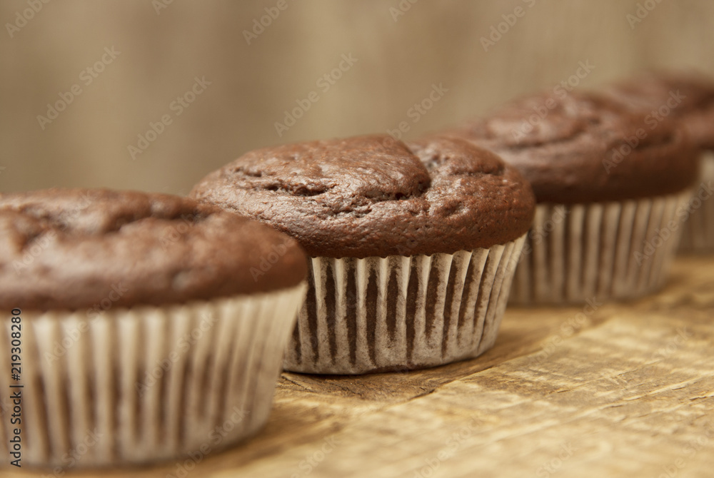 Chocolate muffins. Homemade chocolate muffins with spices on wooden background. Sweet dessert. Chocolate muffins. Homemade chocolate muffins with spices on wooden background. Sweet dessert.