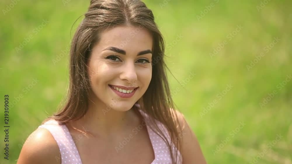 Beautiful lady sit on grass in field