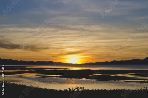 A grand paint like colorful blue and yellow sunset at the great salt lake in utah.