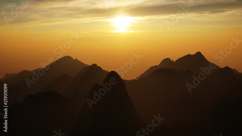 Canvas Print View on Yellow mountains silhouette during sunrise - China