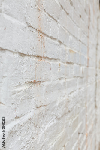 Old brick wall painted white
