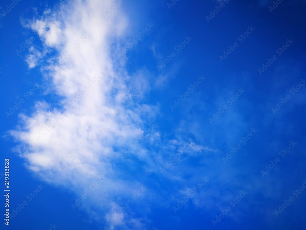 Obraz premium Spring rain clouds against the blue sky
