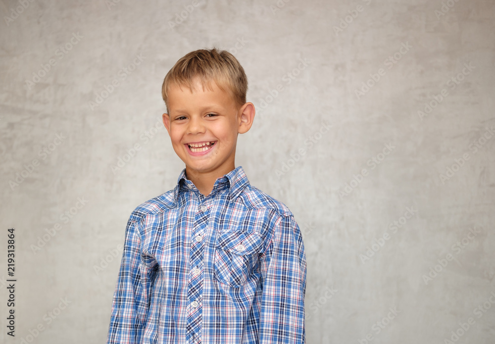 happy European boy with smile on grey background happy European boy with smile on grey background