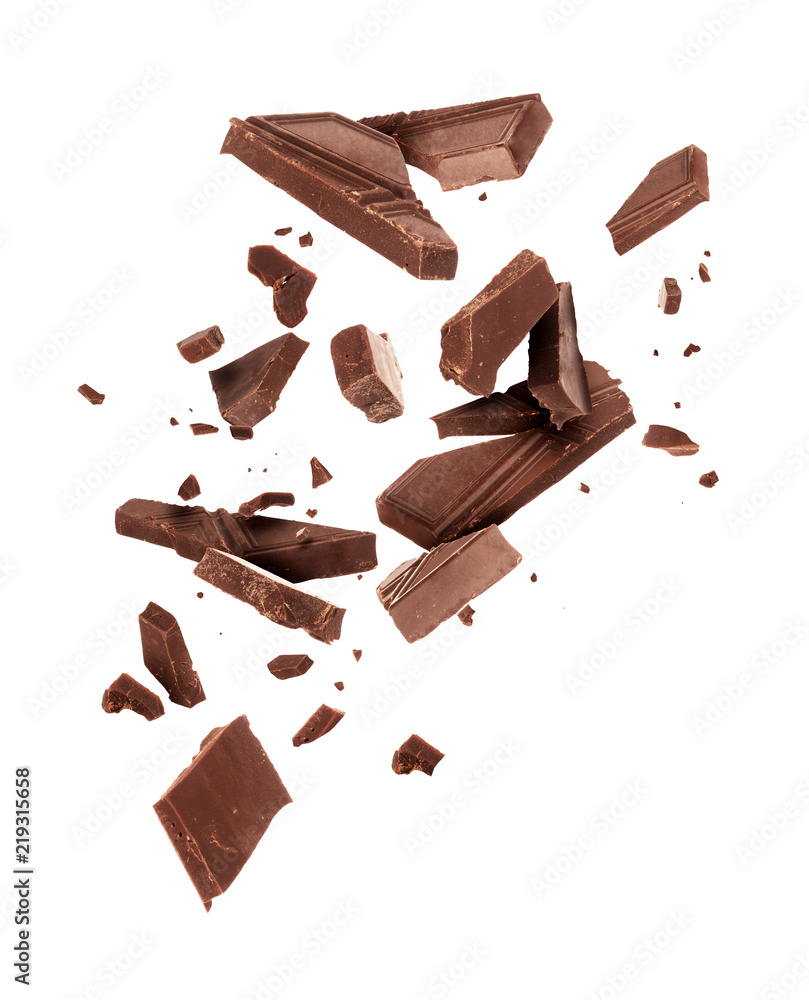 Pieces of dark chocolate falling close up on a white background - obrazy, fototapety, plakaty 