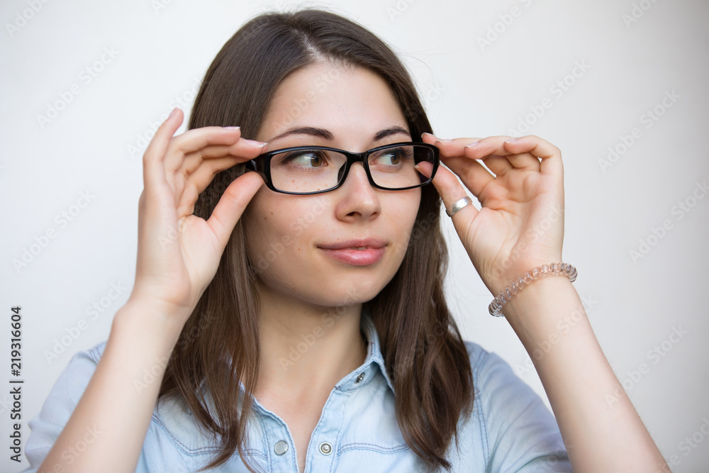 Eyeglasses for good vision, girl on white background with bad sight closeup Eyeglasses for good vision, girl on white background with bad sight closeup