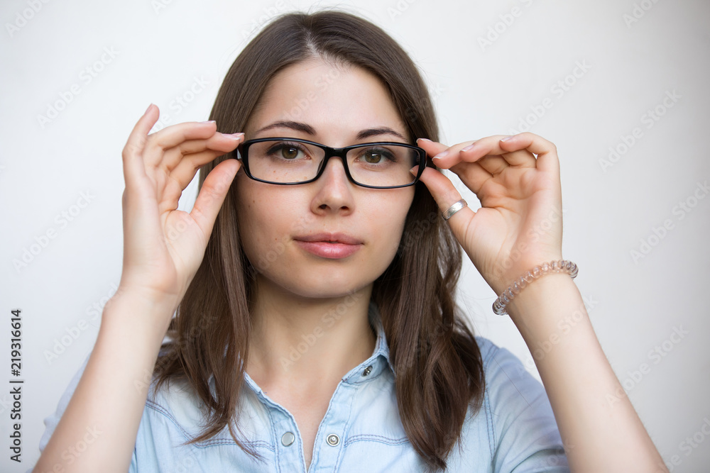 Eyeglasses for good vision, young woman on white background, medical concept Eyeglasses for good vision, young woman on white background, medical concept