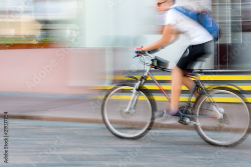 Man riding bicycle in the city, motion blur