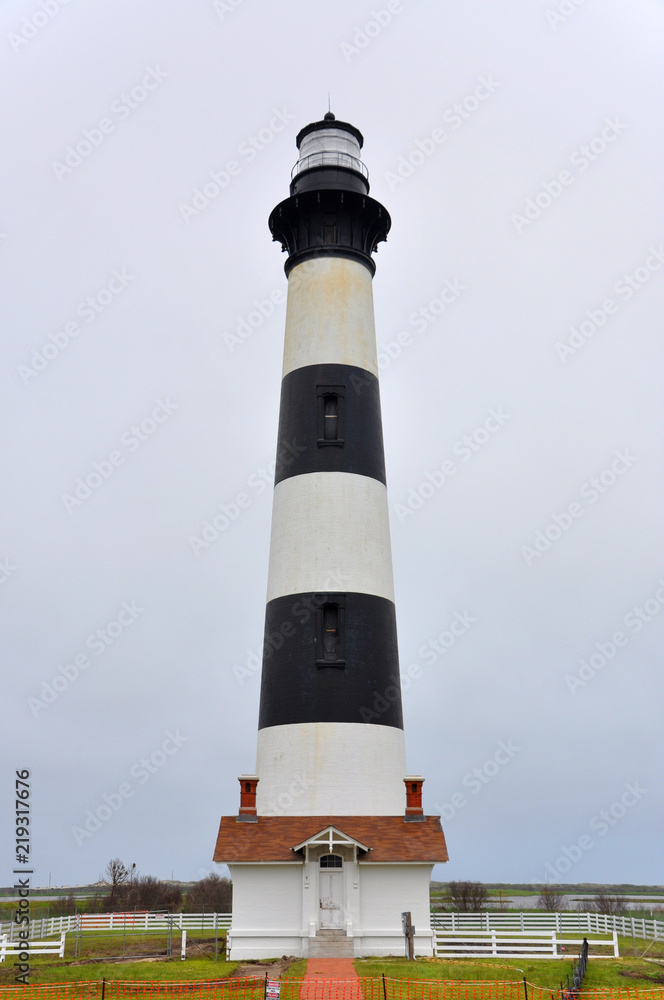 Bodie Island Lighthouse and keeper`s quarters in Cape Hatteras National Seashore, south of Nags Head, North Carolina, USA.