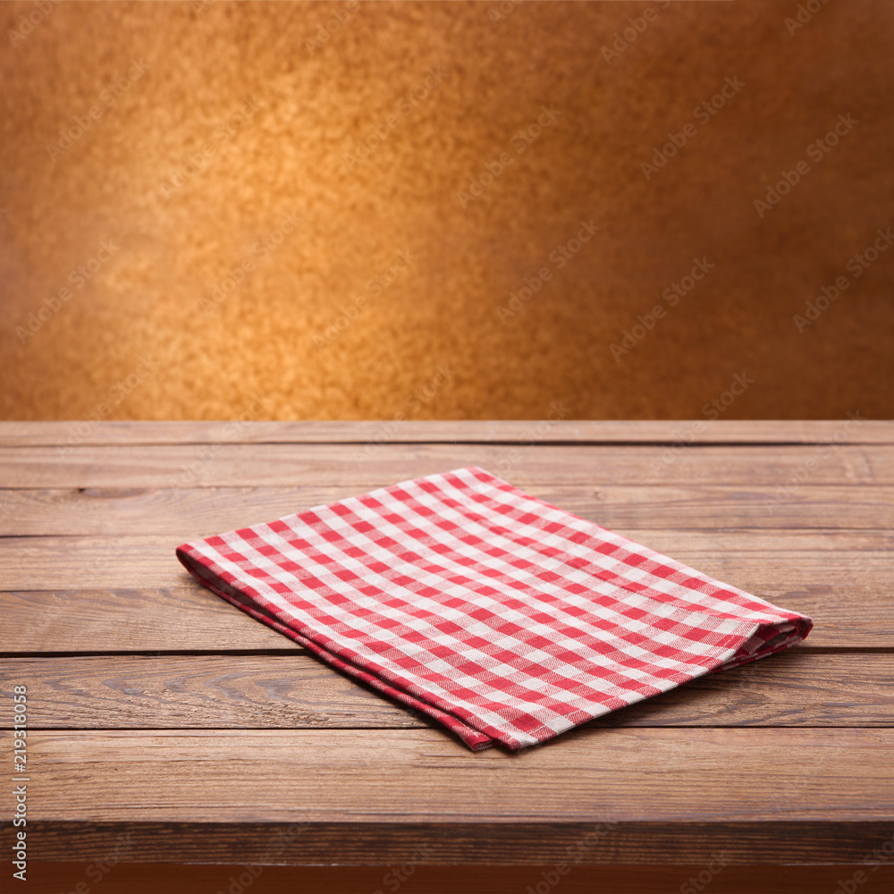 Red checkered tablecloth on wooden table. Napkin close up top view mock up Red checkered tablecloth on wooden table. Napkin close up top view mock up