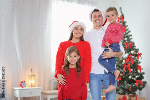 Happy parents celebrating Christmas with children at home
