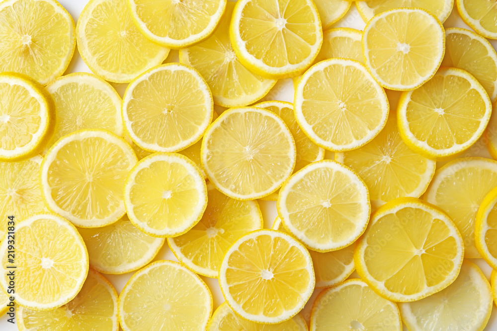 Many slices of fresh ripe lemons as background