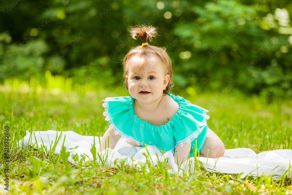 little girl in a dress sitting on a juicy green grass little girl in a dress sitting on a juicy green grass