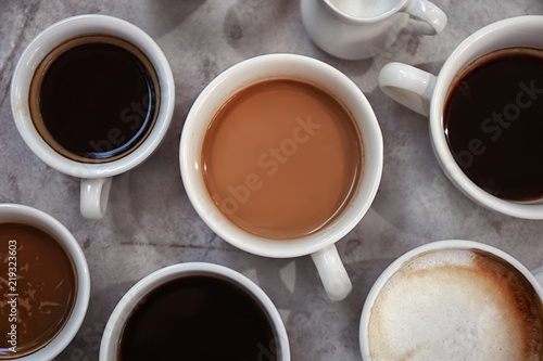 Cups of fresh aromatic coffee on grey background, top view © New Africa