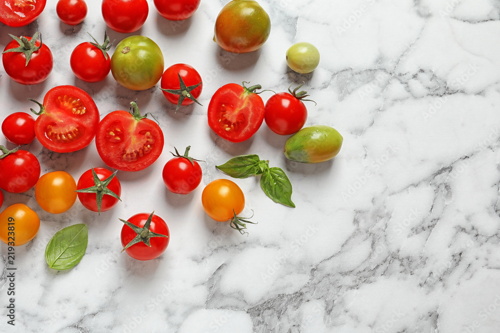 Flat lay composition with juicy tomatoes on marble background
