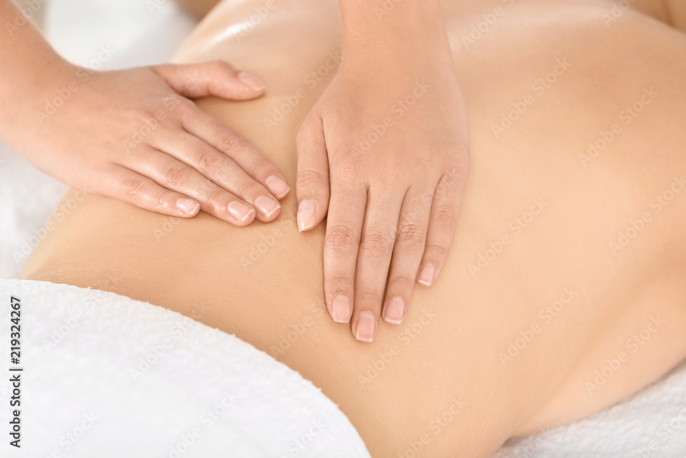 Relaxed woman receiving back massage in wellness center Relaxed woman receiving back massage in wellness center