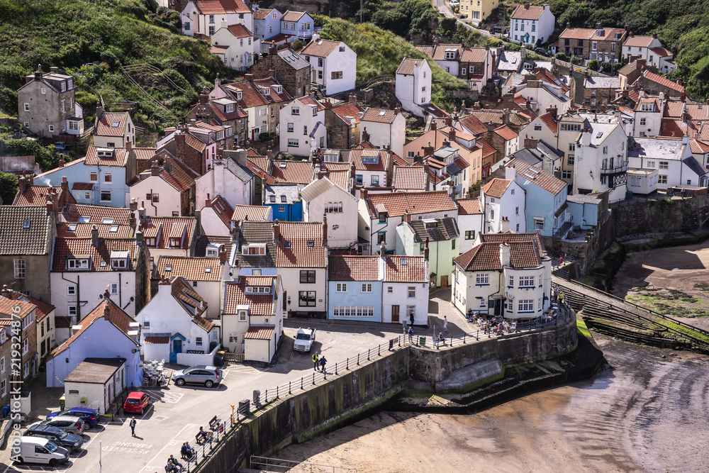 Fototapeta premium A view of the North Yorkshire UK village of Staithes, seen here from from Penny Nab headland.