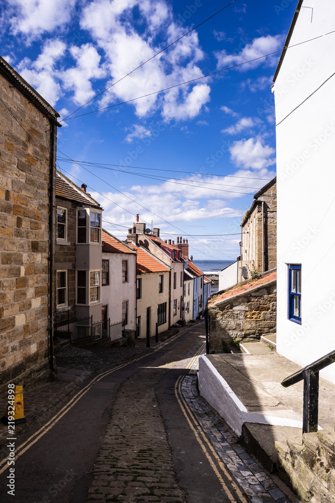 Staithes, North Yorkshire, UK.  A view looking down High Street towards the harbour.