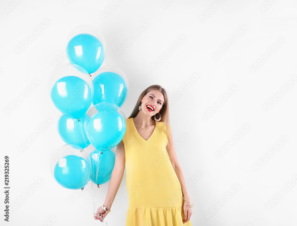 Young woman with air balloons on white background Young woman with air balloons on white background