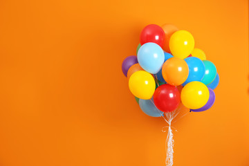 Bunch of bright balloons and space for text against color background