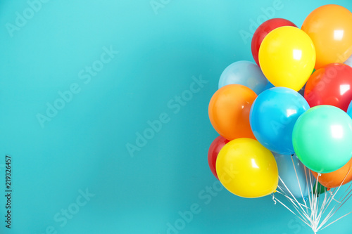 Foto Bunch of bright balloons and space for text against color background
