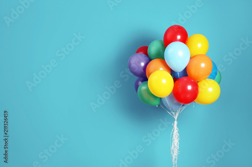 Fototapet Bunch of bright balloons and space for text against color background