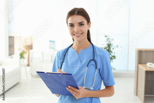 Female medical assistant in clinic. Health care service photo