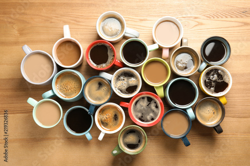 Flat lay composition with cups of coffee on wooden background. Food photography