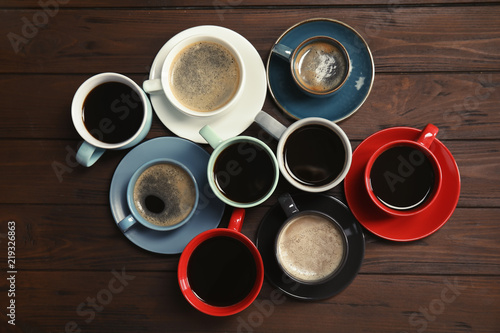 Flat lay composition with cups of coffee on wooden background. Food photography