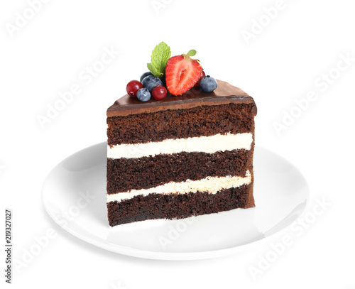 Plate with slice of chocolate sponge berry cake on white background