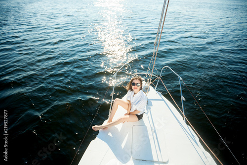 Girl in sunglasses resting on a yacht, sailboat