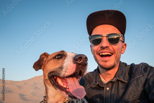 Fototapeta Funny best friends concept: human taking a selfie with dog