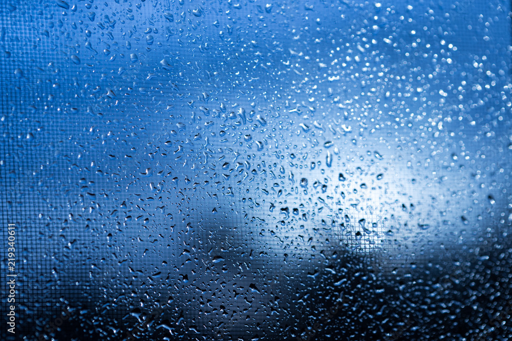 Rain outside the window during sunset. Bright texture of water droplets Rain outside the window during sunset. Bright texture of water droplets
