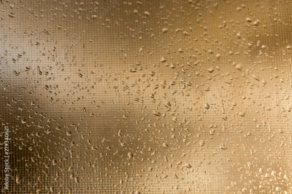 Rain outside the window during sunset. Bright texture of water droplets Rain outside the window during sunset. Bright texture of water droplets