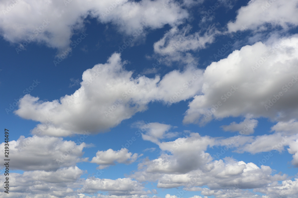 Fototapeta premium Fluffy white clouds against blue sky