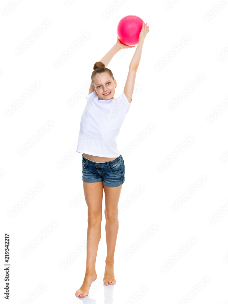 Little girl is engaged in fitness with a ball. Stock Photo by