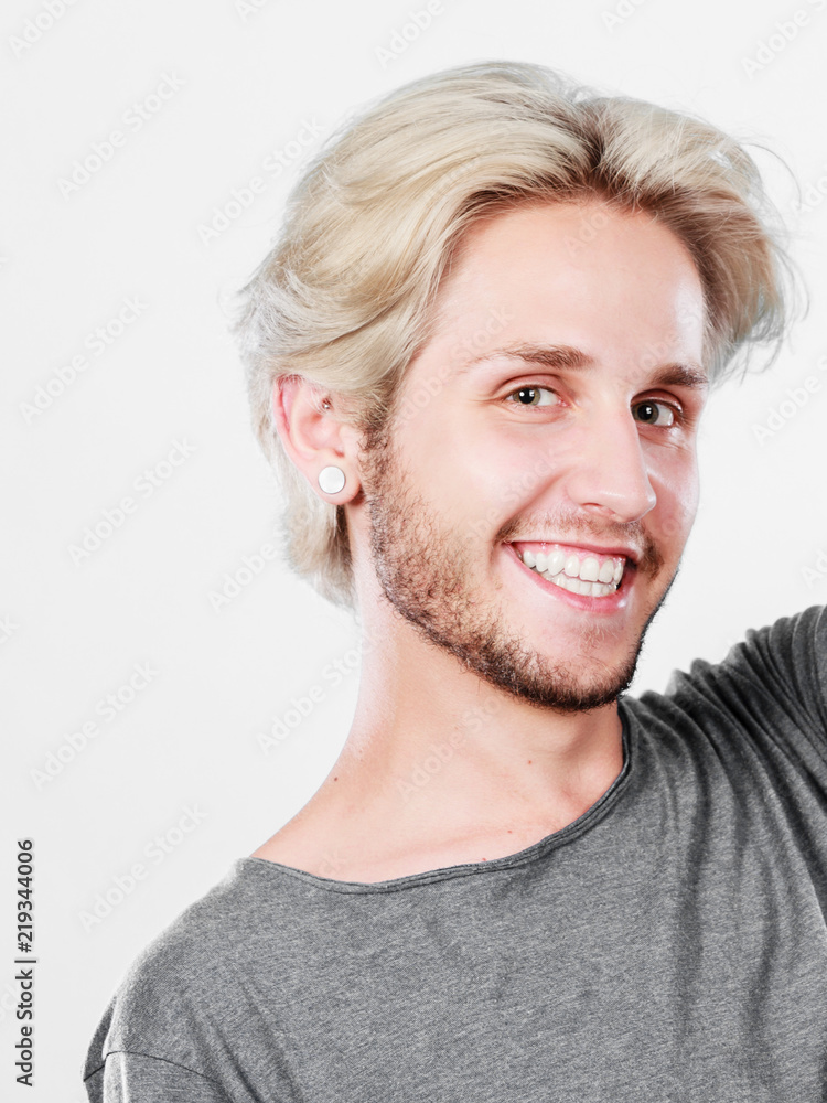 Happy smiling blonde man in grey t shirt Happy smiling blonde man in grey t shirt