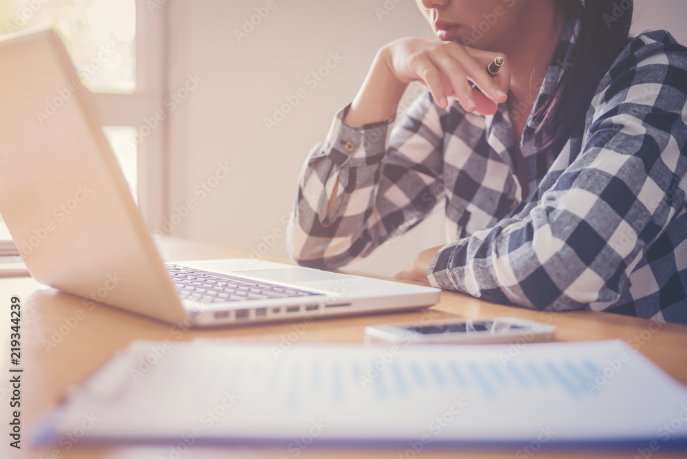 Business man working at office with laptop, tablet and graph data documents on his desk. Business man working at office with laptop, tablet and graph data documents on his desk.