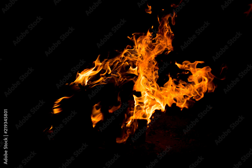 Flame of fire with sparks on a black background Flame of fire with sparks on a black background