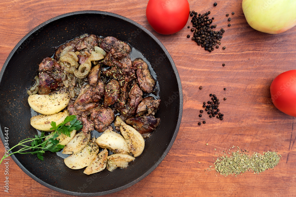Dinner from fried liver with apples and onions, near on little wooden table black pepper, dry grass, red entire tomatoes, kind of from above. Dinner from fried liver with apples and onions, near on little wooden table black pepper, dry grass, red entire tomatoes, kind of from above.