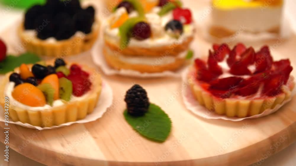 Revolving wooden display with gourmet desserts Revolving wooden display with gourmet desserts